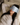 Woman lying on a bed wearing a Light Blue Deep Restoration silk sleep mask and resting on a white silk pillowcase, eyes covered, relaxed in soft natural light.