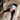 Woman lying on a bed wearing a Light Blue Deep Restoration silk sleep mask and resting on a white silk pillowcase, eyes covered, relaxed in soft natural light.
