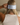 The back of a woman's head showing the back of her light blue silk sleep mask wrapped around her head. 