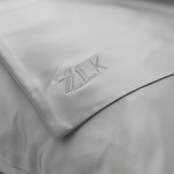 ZILK embroidered logo on light gray silk pillowcase